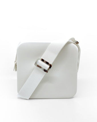 A white silicone rubber crossbody bag with an adjustable strap and a zipper closure.